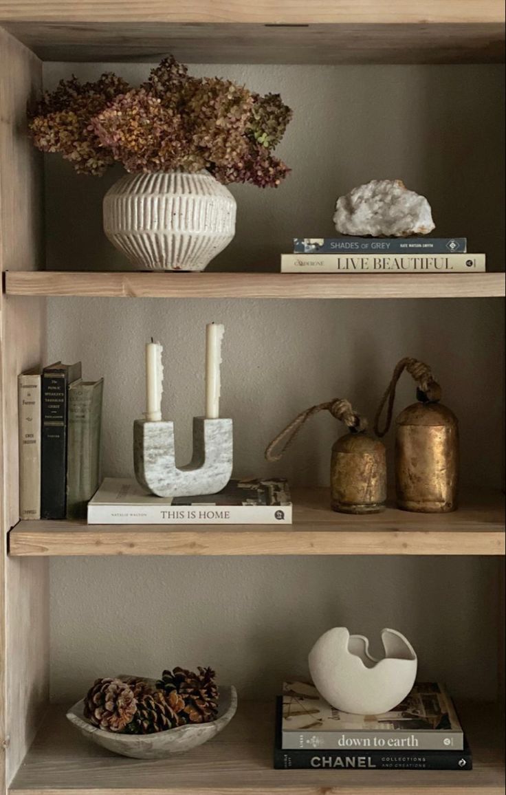 shelves with books, candles and vases on them