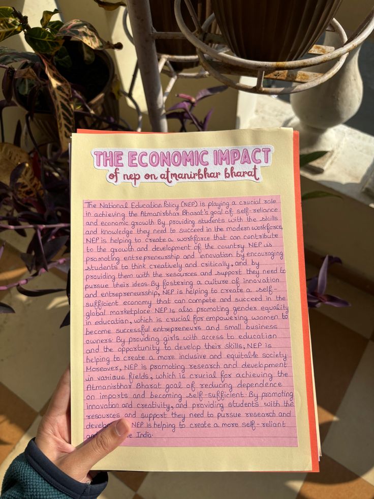 a person holding up a pink paper with the economic impact of naps on another planet