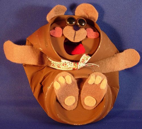 a paper mache bear with sunglasses on it's head and paws in the air