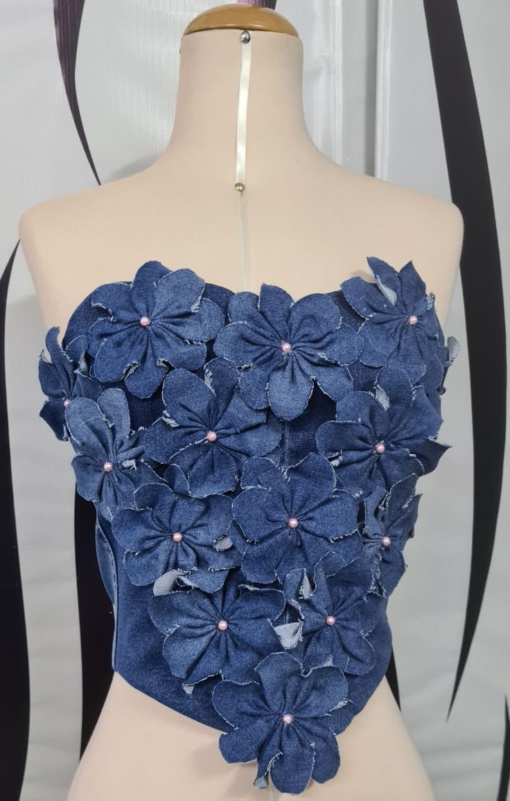 a mannequin with blue flowers on it's chest and one piece of fabric