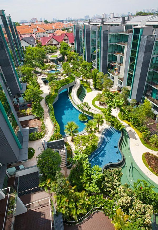 an aerial view of the pool and surrounding buildings in a city with trees, bushes and plants