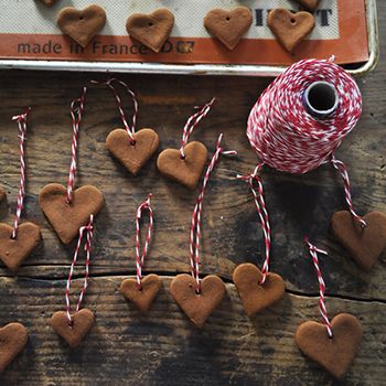 gingerbread hearts and twine spools are arranged on a wooden table with the words 12 days of diy