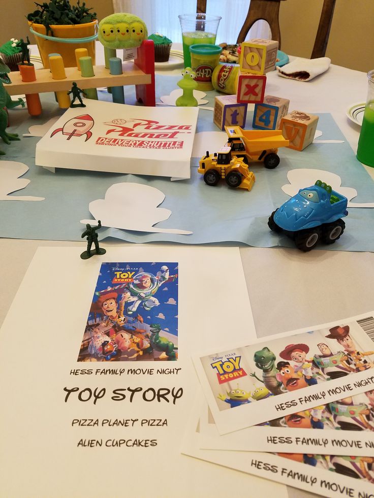 the table is set up with toy story cards and other items for children's birthday party