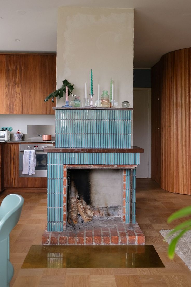 a living room filled with furniture and a fire place in the middle of a kitchen