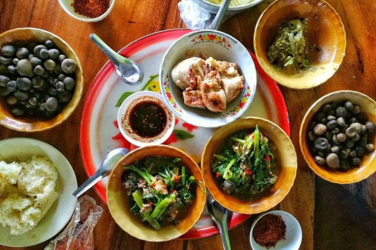 a table topped with bowls filled with different types of food and condiments on top of it