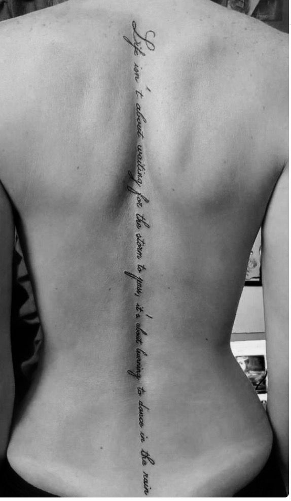 the back of a woman's neck with writing on it