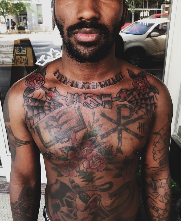 a man with lots of tattoos on his chest