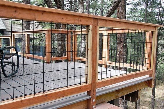 a wooden deck with metal bars and railings