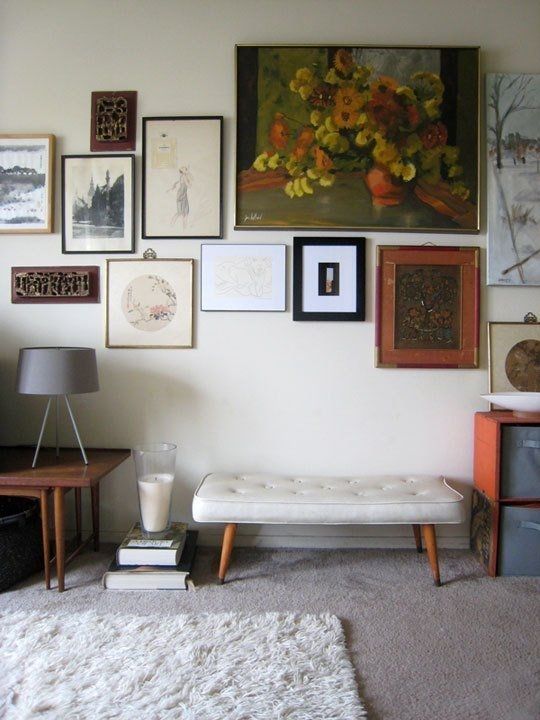 a living room filled with furniture and pictures on the wall