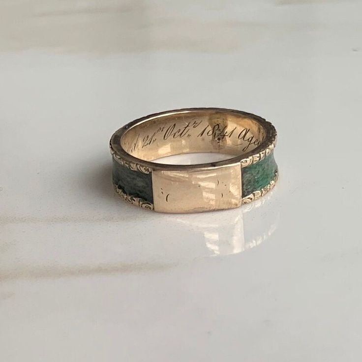 An Antique 15 carat gold mourning ring displaying beautiful hair work around the entire ring. Engraving reads: Died 21st Oct 1841 aged 72 CONDITION: Wear consistent with age and use. Some water damage to hair work. Please see photos for more detail. BAND WIDTH: 5mm RING SIZE: UK: L | US: 5 3/4 WEIGHT: 2.6g (UUZ) Ring Displays, Lovely Earrings, Amethyst Ring, Gold Style, Gold Bands, Garnet, Beautiful Rings, Band Rings, Ring Size