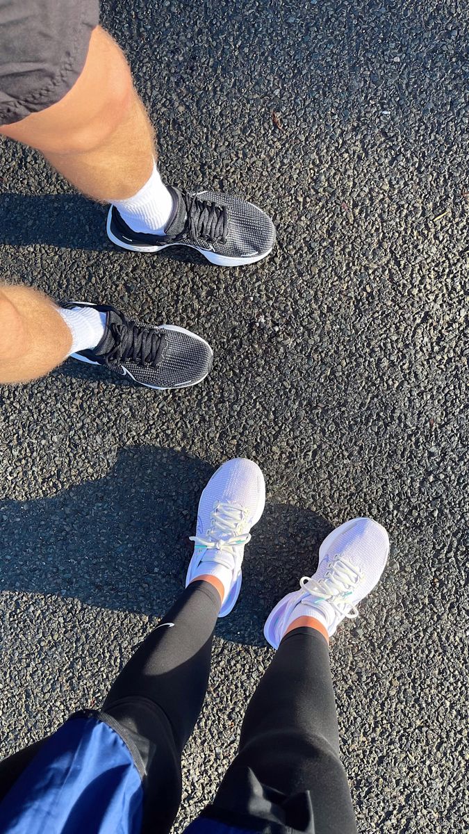 two people standing next to each other with their feet in the air and one person wearing white shoes