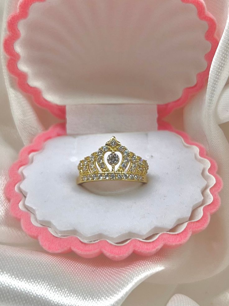 a princess tiara ring in a pink and white box