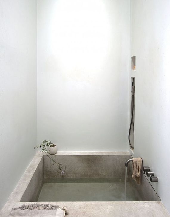 a bathroom with a bathtub and shower head