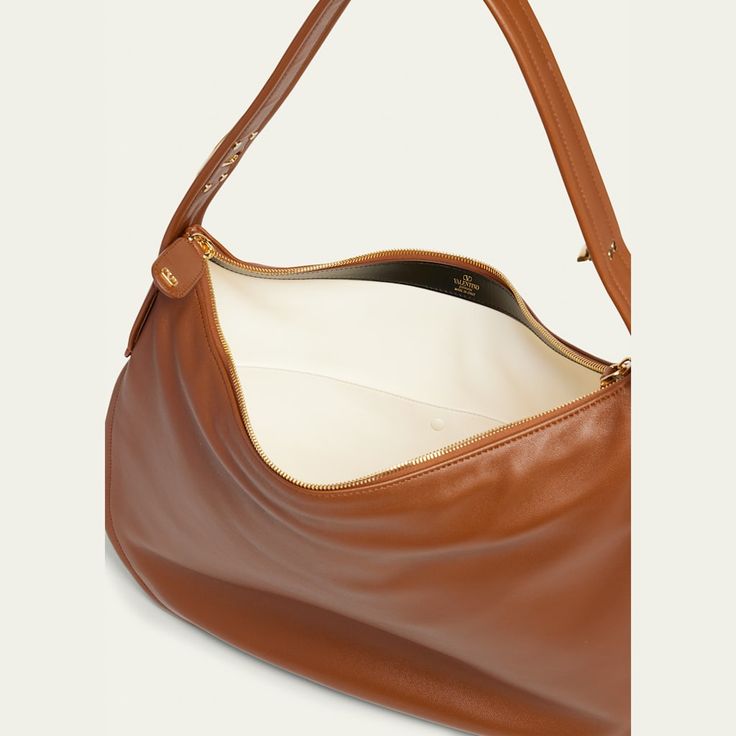 Valentino Garavani "Go" hobo bag in leather Shoulder strap with VLOGO snap closure  Convertible to a top handle  Can be worn as a shoulder or top handle bag  Two-way zip top closure  Interior, one slip pocket  Lining: Leather Approx. 12.2"H x 17.3"W x 2"D Made in Italy Luxury Hobo Bag With Leather Trim And Double Handle, Luxury Leather Trim Hobo Bag, Luxury Hobo Bag With Leather Trim, Luxury Hobo Bag With Leather Lining For On-the-go, Luxury Leather-handled Hobo Shoulder Bag, Leather Hobo Bag, Leather Hobo, Hobo Bag, Valentino Garavani