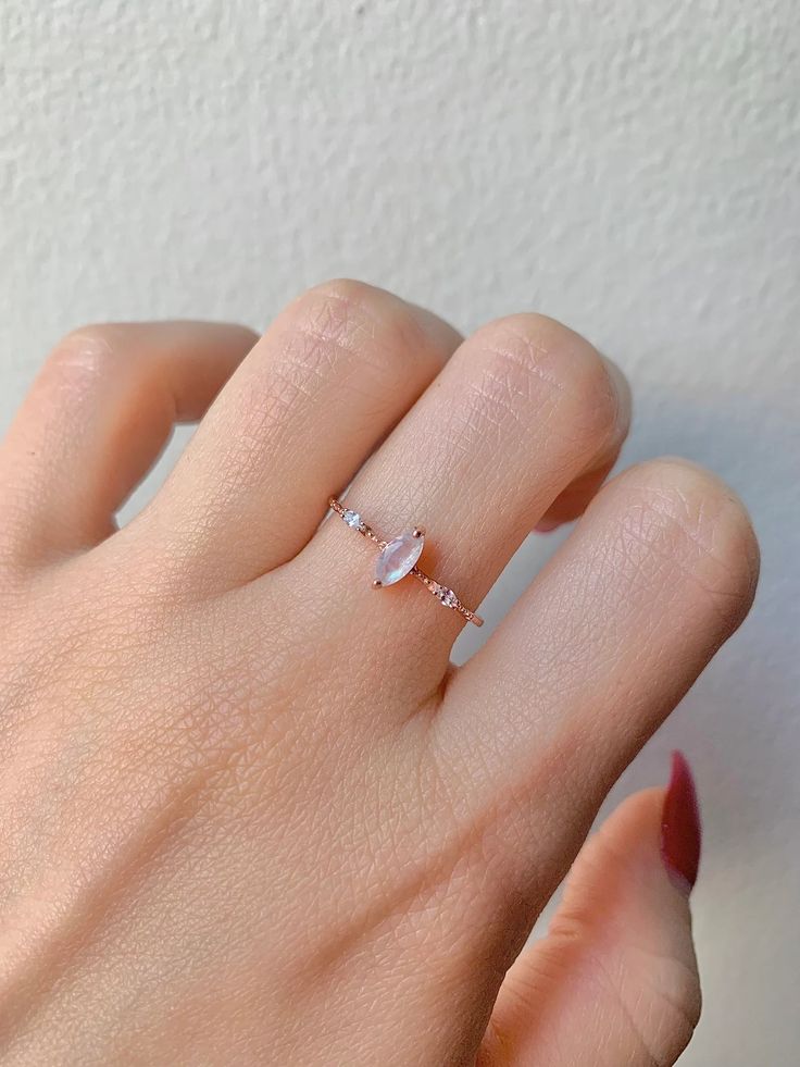 We absolutely adore the pale and gentle colors of natural moonstone gems, and this is perfectly complimented by our stunning Aya design and gold materials for an unbeatable, iconic look. Each Aya ring is finished with a .50 carat central gemstone and minute CZ crystals for a shine that’s unlike any other. ✦ DETAILS ✦✧ Handcrafted ✧ 0.5 Carat center stone✧ Moonstone and cz crystals ✧ Sizes 3.5-11.25✧ This ring will arrive ready to gift in a Kherish velvet box. Delicate 14k Gold Moonstone Ring, Rose Gold Moonstone Ring With Rose Cut Diamonds, 14k Gold Minimalist Moonstone Promise Ring, Rose Gold Moonstone Ring As A Gift, Delicate White Moonstone Gemstone Ring, Delicate White Moonstone Ring, Dainty Rose Gold Moonstone Jewelry, Delicate White Moonstone Ring In 14k Gold, Dainty Opal Ring In Rose Gold