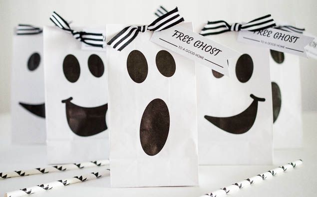 three bags decorated with black and white ghost faces