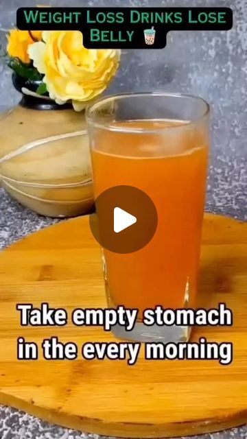 a wooden tray topped with a glass of orange juice