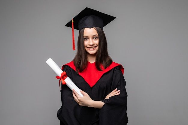 a woman wearing a graduation cap and gown with her arms crossed in front of her chest