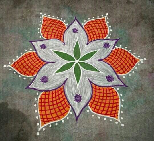 an artistic flower design painted on the ground with white and orange dots in the center