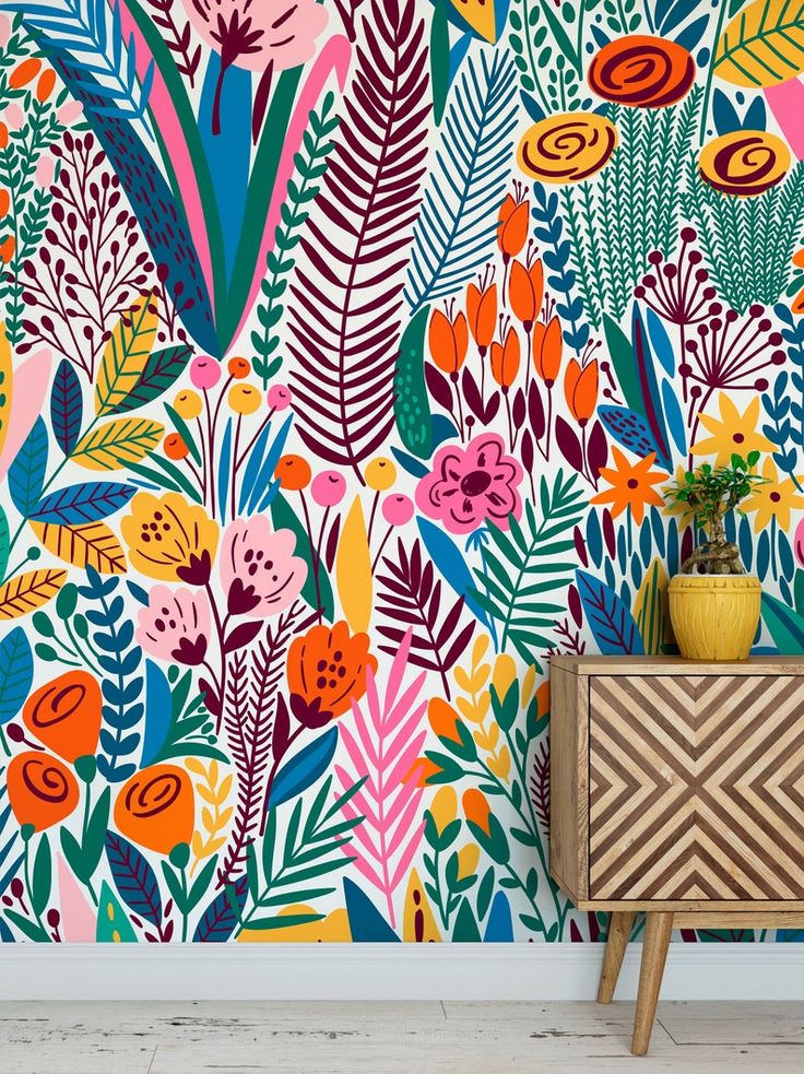 a colorful wallpaper with flowers and plants on the sideboard next to a planter