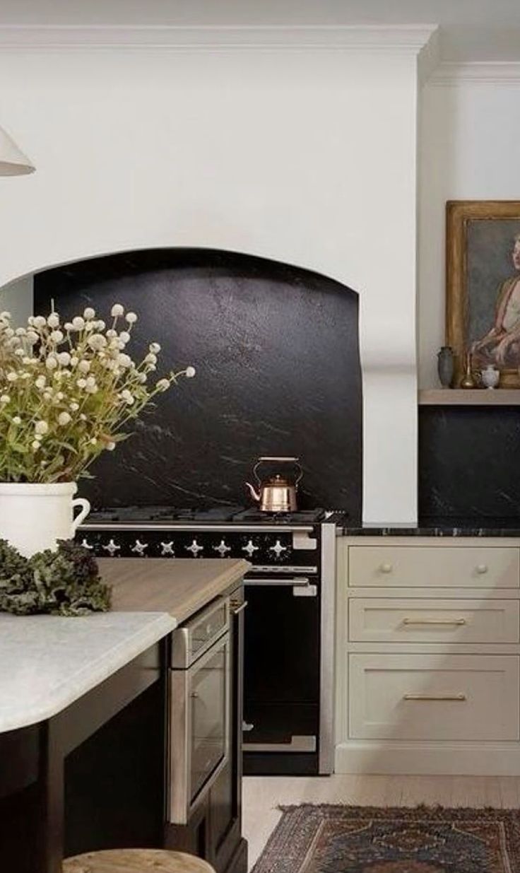 a kitchen with an oven, sink, and counter top in it's center