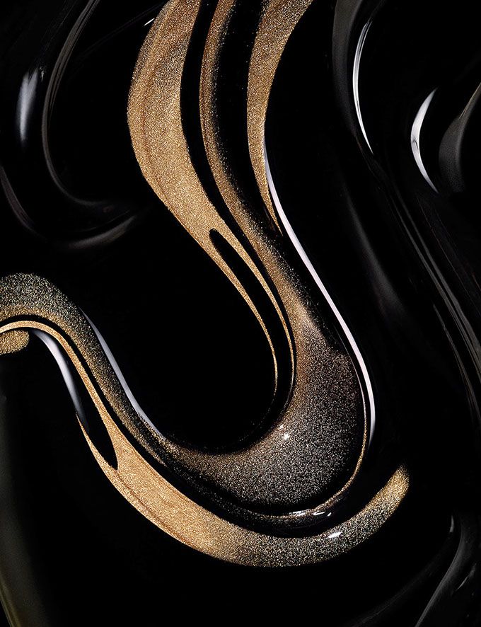 an abstract black and gold background with curves