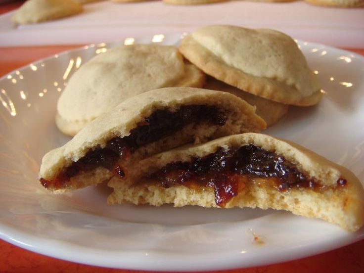 two pastries on a plate with jam in the middle