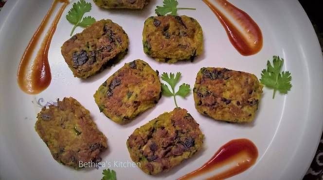 four crab cakes on a white plate with ketchup