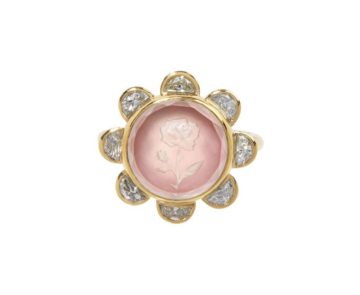 With its feminine design and color, this Renna ring is a stunning take on the traditional cocktail ring. Etched in the round rock crystal is a delicate, thorny rosebud which has been backed by pink opal. Eight shimmering half moon diamonds are set in 18K yellow gold bezels and surround the composition. It's set at the center of round, polished 18K yellow gold band. ring face : 7/8" diametercrystal quartz : 13mm diameterdiamonds : 3mm x 4mm each : .88cttw18K yellow gold band width : 2mmsize avail Pink Oval Jewelry With Single Cut Diamonds, Oval Pink Jewelry With Single Cut Diamonds, Diamond Intaglio Jewelry, Round Diamond Intaglio Jewelry, Exquisite Pink Round Rings, Pink Diamond Ring With Single Cut Diamonds, Diamond Intaglio Rings, Fine Jewelry, Diamond Intaglio Fine Jewelry Rings, Heirloom Flower Ring With Rose Cut Diamonds