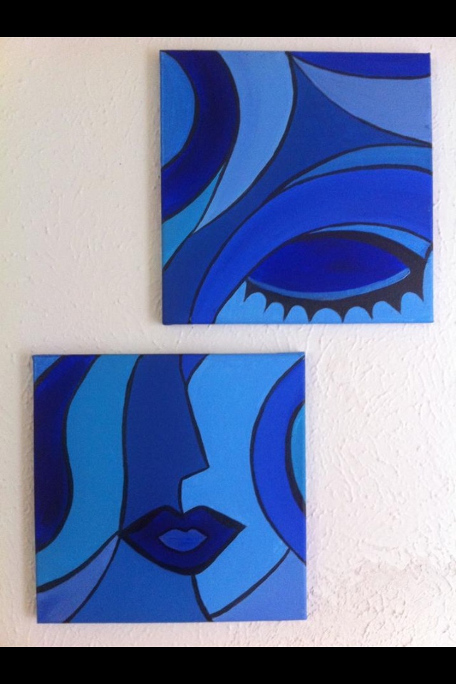 two blue paintings are hanging on the wall