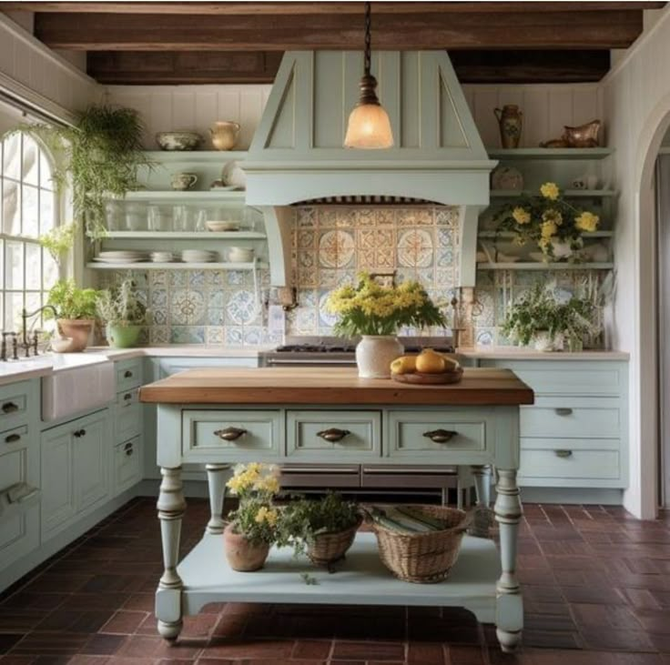 a kitchen with an island in the middle and lots of pots on top of it