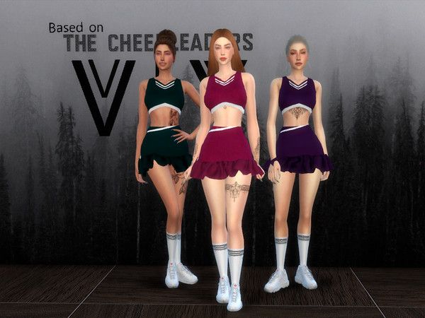 three female cheerleaders are standing in front of a wall with the word v on it