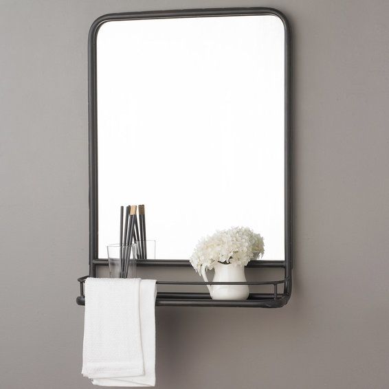 a bathroom with a sink, mirror and towel rack on the wall in front of it