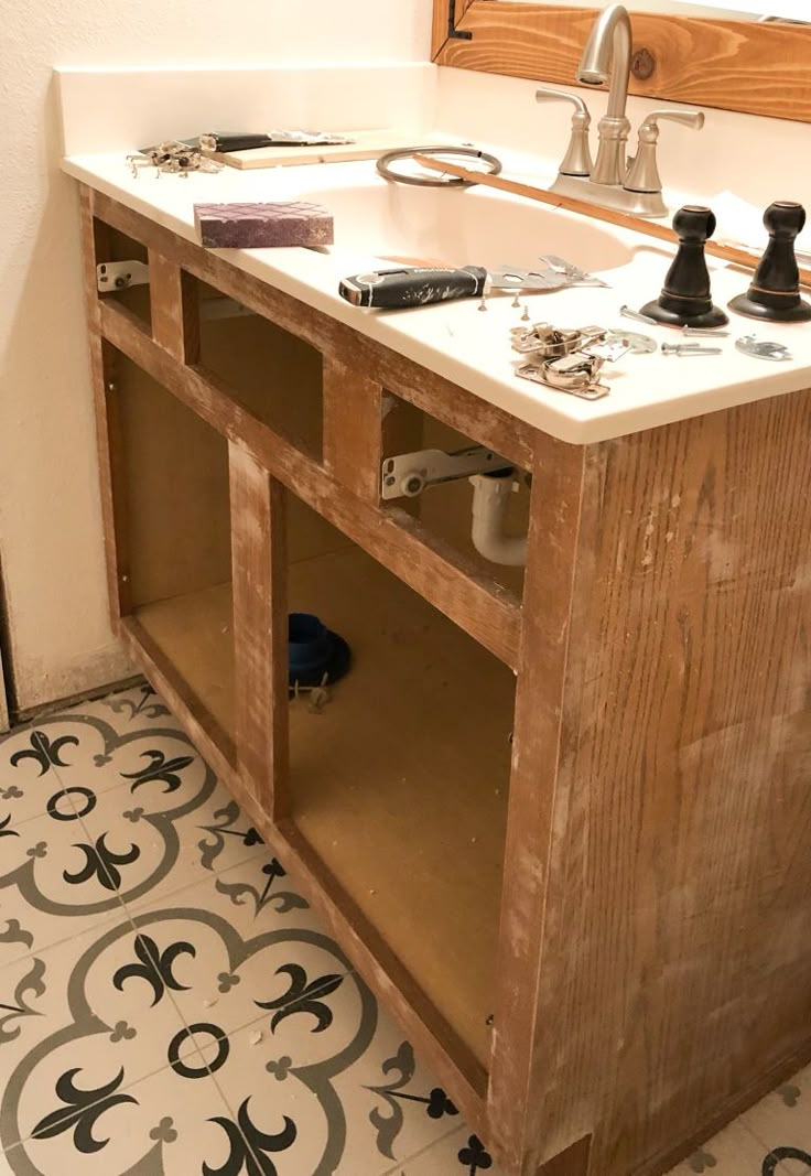 a bathroom with a sink and wooden cabinets