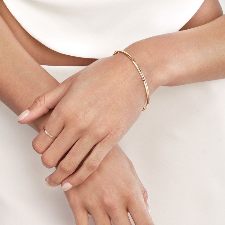 Let your style speak volumes with the subtle elegance of our Polished Hinged Bangle from Olas d'Oro. This exquisite 14K yellow gold bangle is more than just jewelry; it's a statement of your unique style.Crafted to perfection, this 3mm x 1.5mm bangle boasts a polished finish that catches the light with every movement, adding a touch of brilliance to your ensemble. Its hinged design ensures ease of wear, and the secure snap-lock clasp guarantees it stays comfortably in place.The beauty of this ba 14k Gold Bracelets With Polished Finish, Elegant Formal Jewelry With Smooth Finish, Timeless Adjustable Gold Bracelet With Polished Finish, Adjustable 14k Gold Bangle, Fine Jewelry, Classic Adjustable 14k Gold Chain Bracelet, Classic Flexible Bangle Bracelet, Classic Flexible Bangle Bracelets, Elegant Everyday Stackable Bangle, Classic Rose Gold Diamond Bracelet With Polished Finish