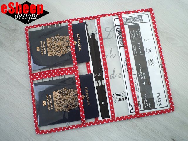 two passport holders sitting next to each other on top of a white table with red polka dots