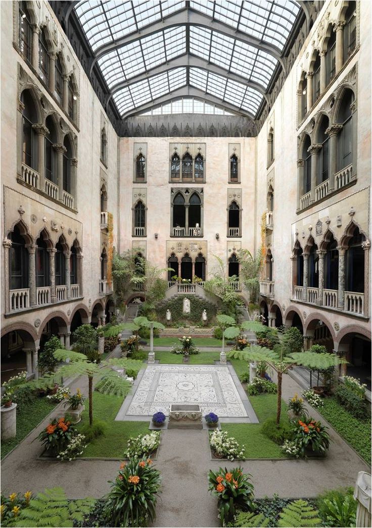 an indoor courtyard with many plants and flowers