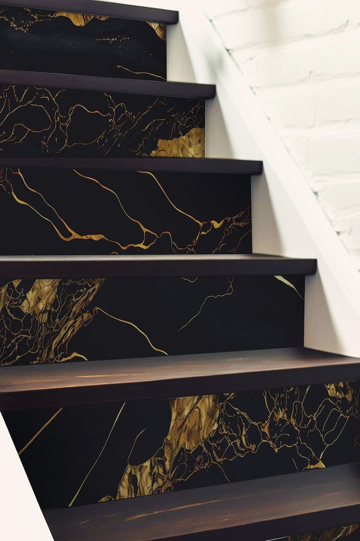 the stairs are decorated with black and gold marble