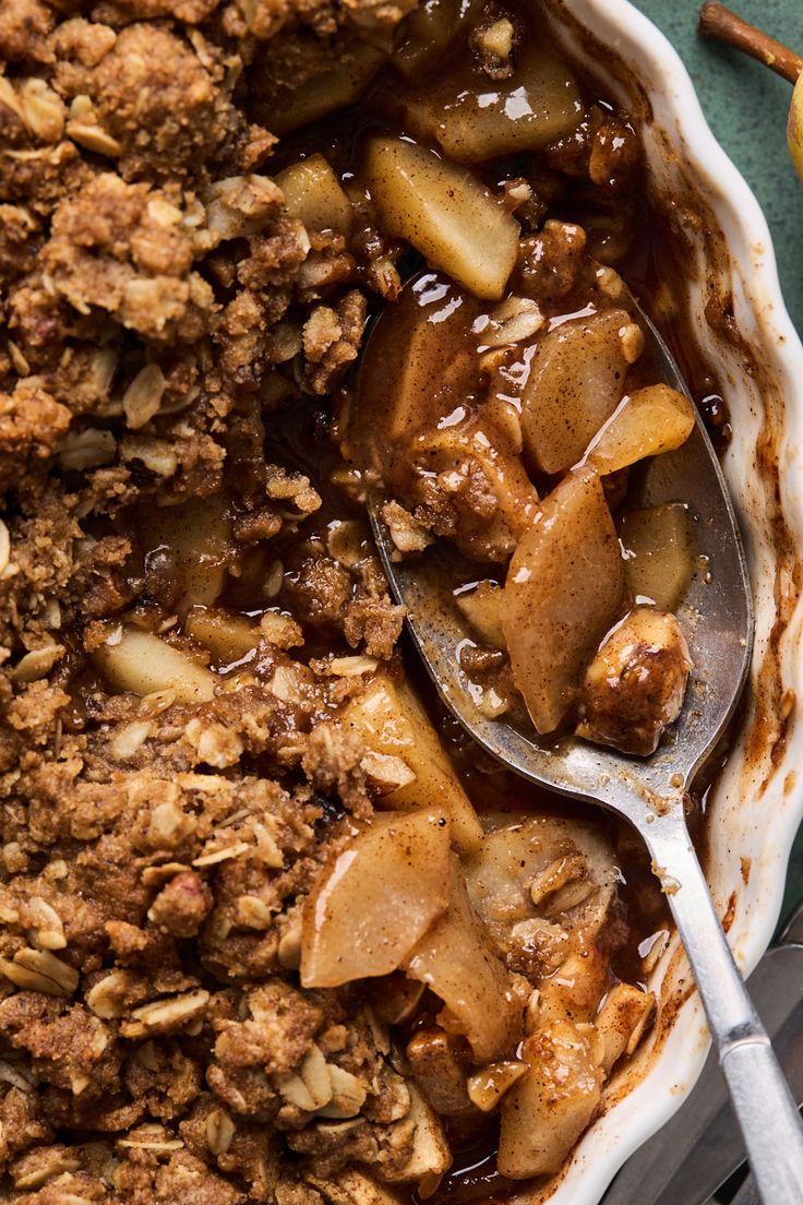 a bowl filled with apple crumbled oatmeal on top of a table