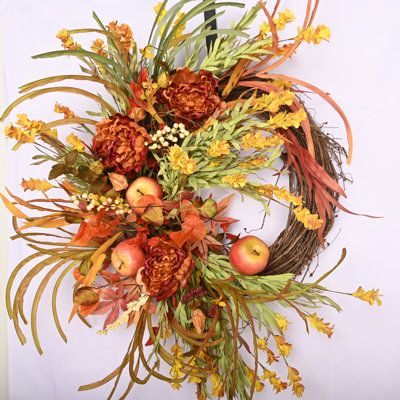 an arrangement of flowers and leaves on a white background with the letter o in the center