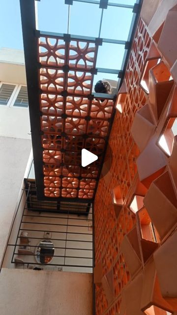 an overhead view of a building with orange walls and geometric designs on the side wall