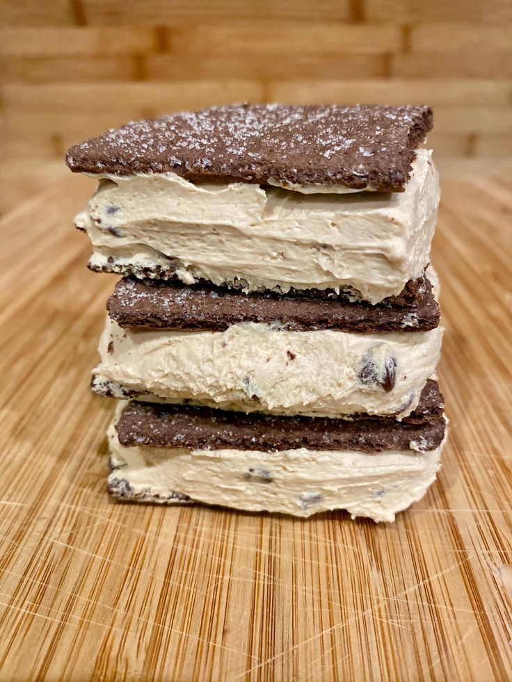 three pieces of cake sitting on top of a wooden cutting board