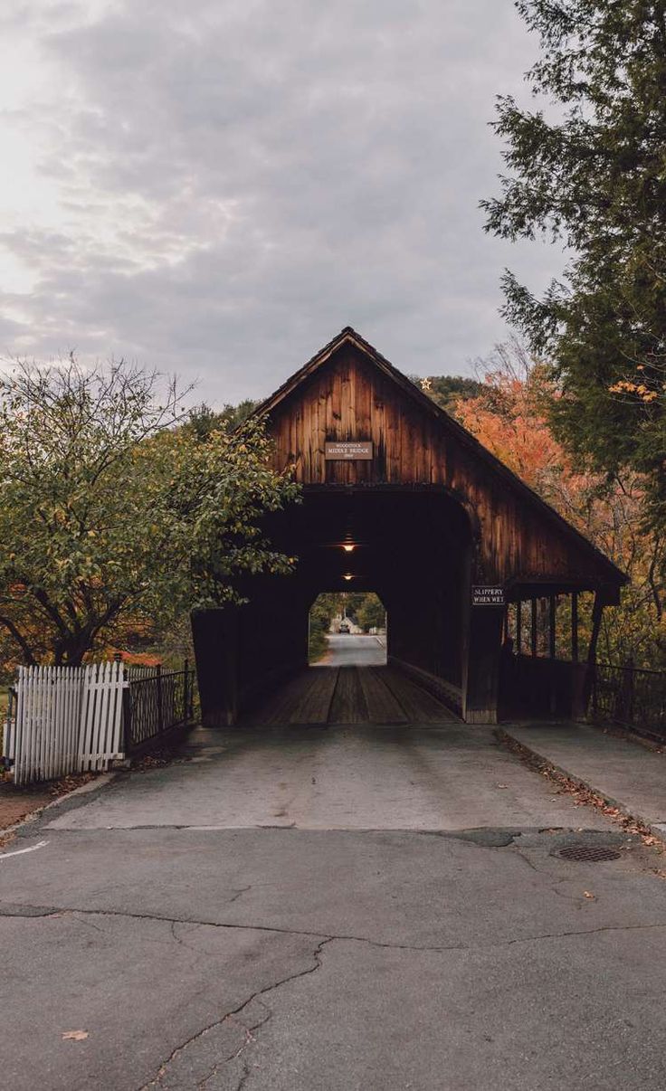 an old wooden covered bridge in the fall