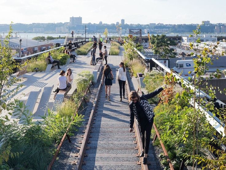 people are walking up and down the stairs in an urban area with lots of greenery