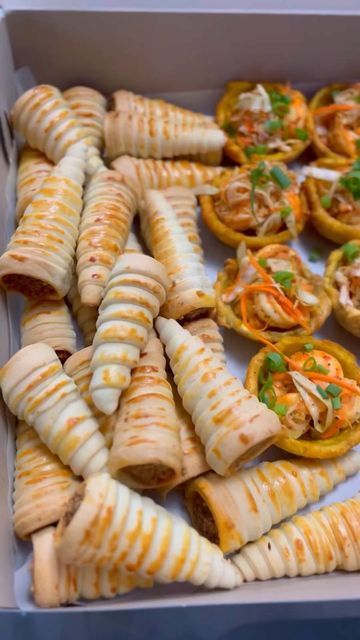 a box filled with different types of appetizers on top of a table next to each other