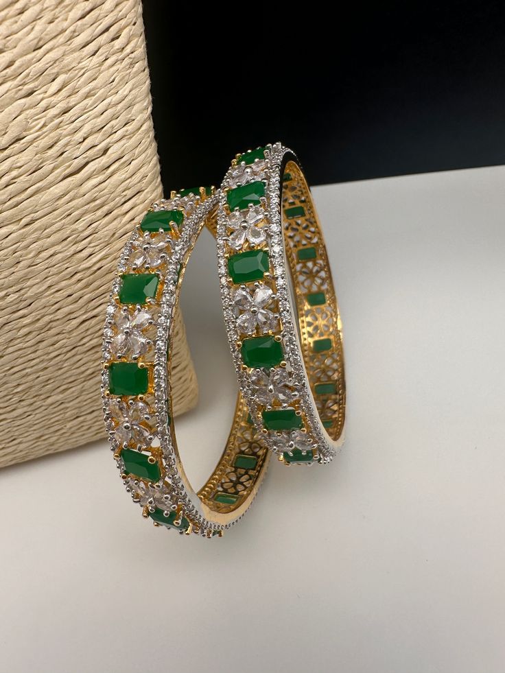 Traditional Bangles comes in set of 2Color : GoldSize : Size : 2.4Stones : AD Red Stones Emerald Diamond Bangles, Green Stone Bangles, Diamonds Bangles, Green Bangles, Traditional Bangles, Red Stones, Diamond Bangle, American Diamond, Red Stone