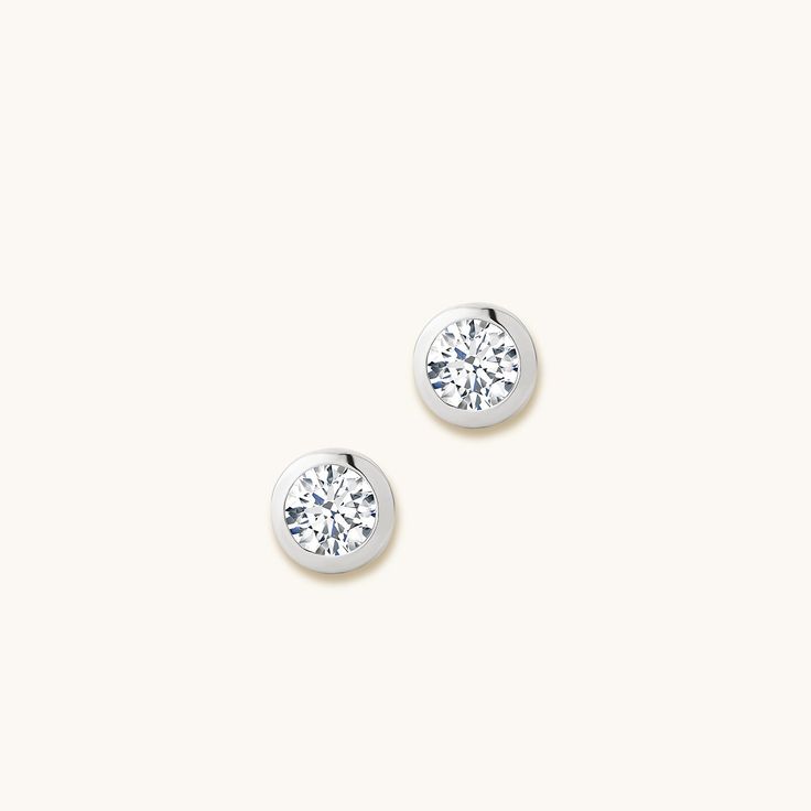 Experience the unparalleled elegance of the Bold Bezel-Set Round Cut Diamond Studs from Jewellers District. Expertly handcrafted by our skilled artisans, these earrings feature stunning lab-grown diamonds set in recycled gold, a testament to our commitment to exceptional Canadian craftsmanship, ethical sourcing, and sustainable practices. Earrings dimensions: 6.4 mm approx. each Accent lab-grown diamonds: 0.70+ ctw, VS2+/F+ Setting: Bezel setting Post length: 11 mm approx. Backing: Butterfly pus Minimalist Round Cut Diamond Earrings With Accents, Luxury Platinum Diamond Earrings With Single Diamond, Refined Diamond Round Earrings, Formal White Gold Diamond Earrings With Round Stone, Timeless Brilliant-cut Diamond Earrings In Sterling Silver, White Gold 14k Diamond Earrings With Single Diamond, Sterling Silver Diamond White Earrings With Round Stone, Timeless Earrings With Diamond Accents In Lab Grown Diamond, White Gold Platinum Diamond Earrings With Single Diamond