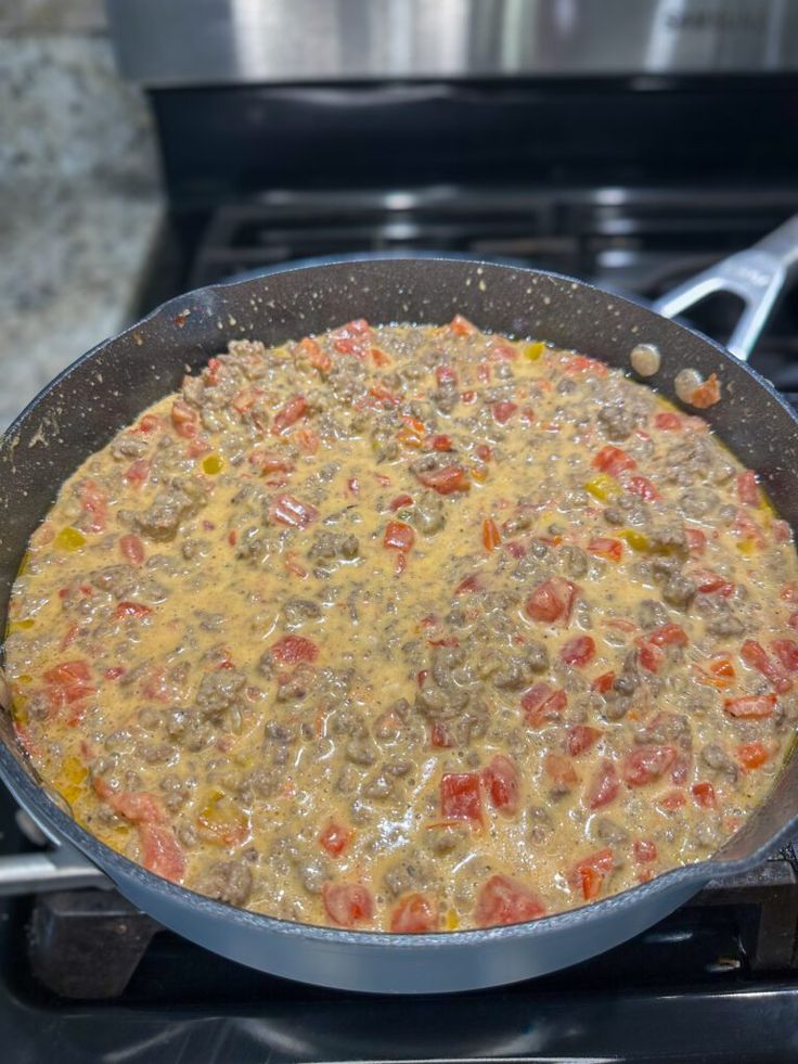 a pan filled with food sitting on top of a stove