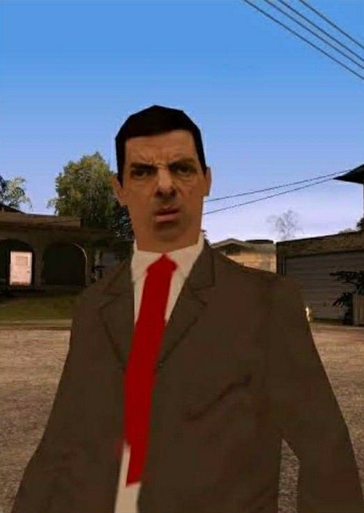 a man in a suit and red tie standing in the middle of a street with houses behind him