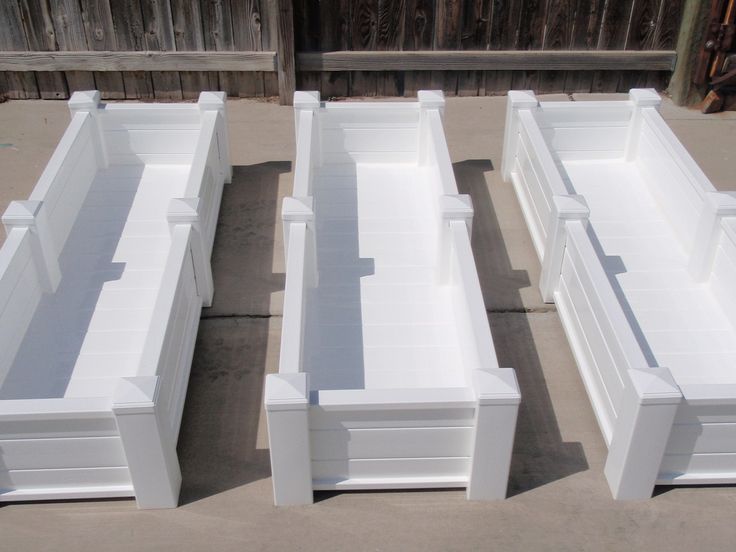 four white boxes sitting on top of cement